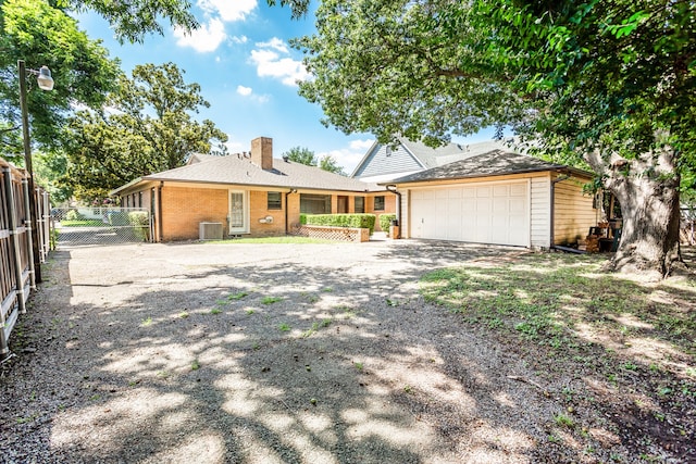 view of front of house with central AC and a garage