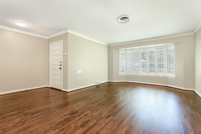 spare room featuring ornamental molding and dark hardwood / wood-style flooring