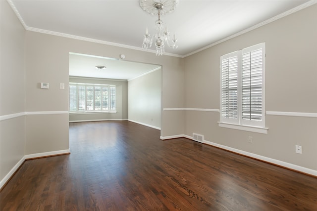 unfurnished room with ornamental molding, an inviting chandelier, and dark hardwood / wood-style flooring