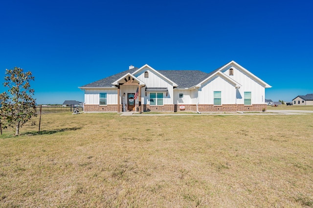 view of front of home with a porch and a front lawn