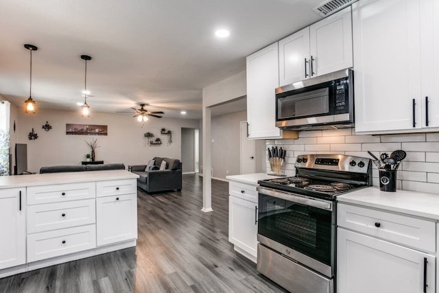 kitchen with ceiling fan, pendant lighting, white cabinets, stainless steel appliances, and hardwood / wood-style floors