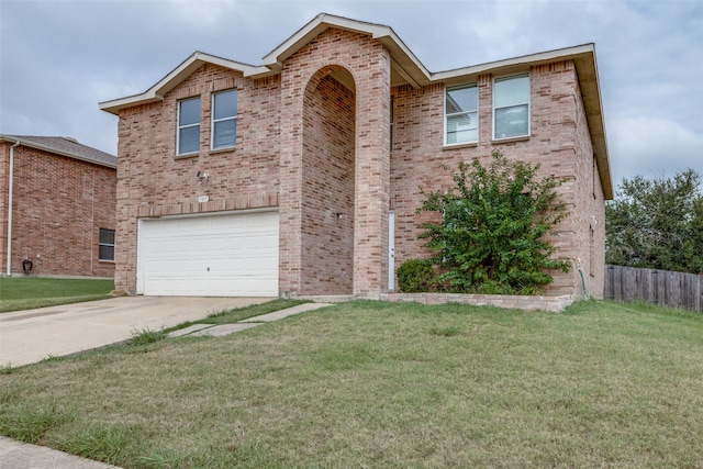 view of front of home with a garage and a front lawn