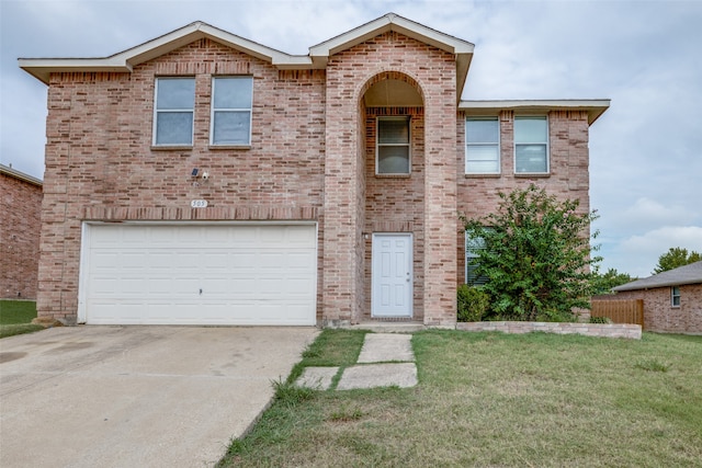 view of front of home with a front yard and a garage