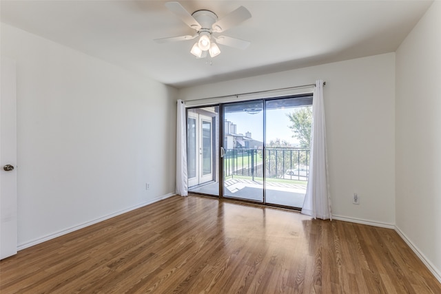 empty room with ceiling fan and hardwood / wood-style flooring