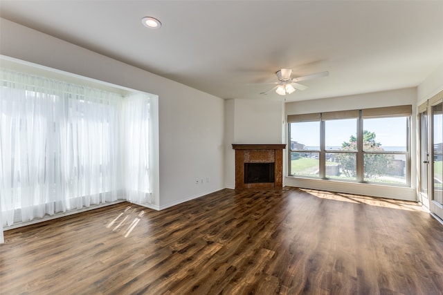 unfurnished living room with ceiling fan and dark hardwood / wood-style floors