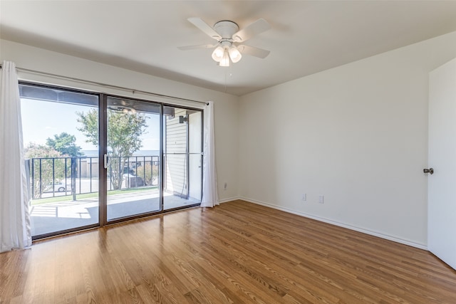 empty room with hardwood / wood-style floors and ceiling fan