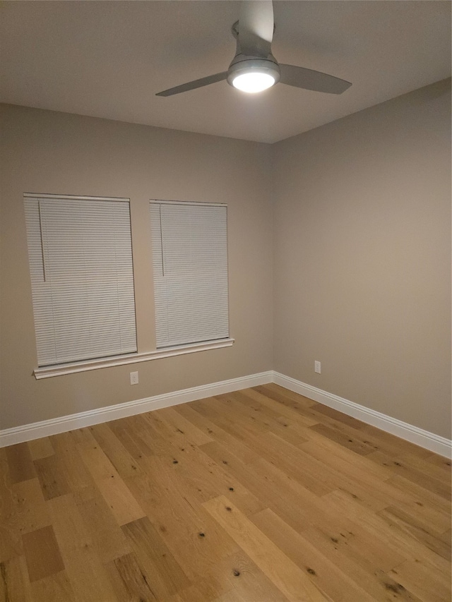 empty room featuring ceiling fan and light hardwood / wood-style flooring