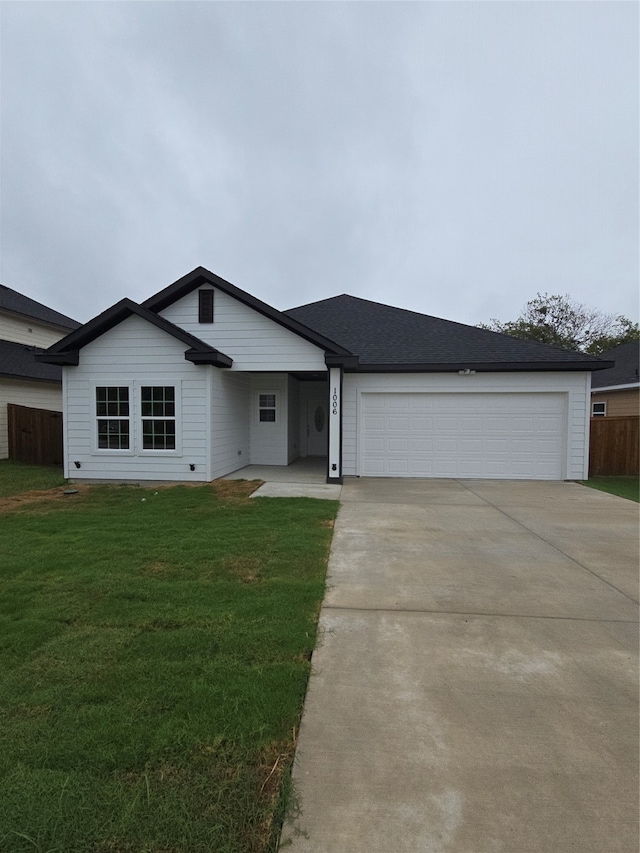 ranch-style home with a front lawn and a garage