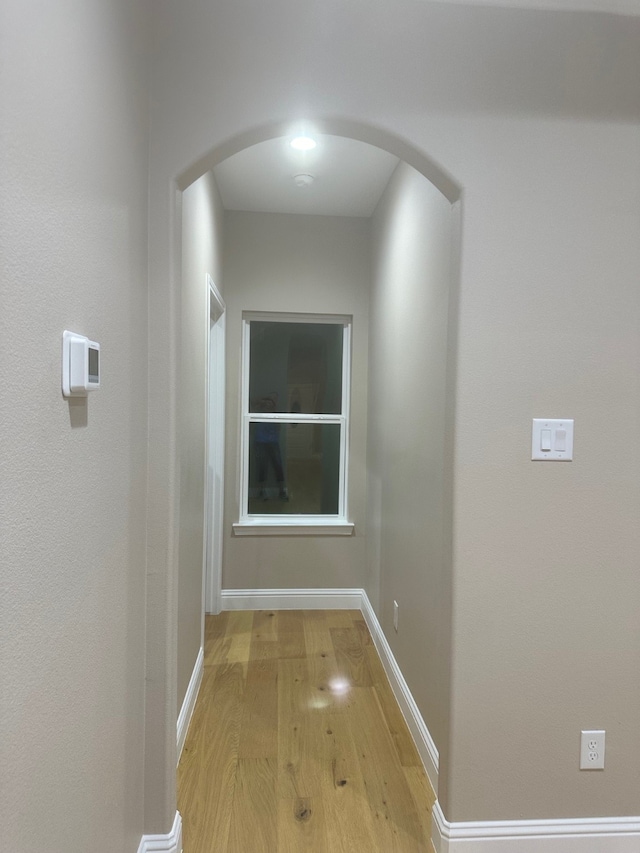 hallway with light hardwood / wood-style flooring