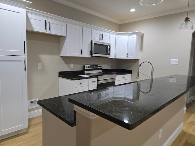 kitchen featuring pendant lighting, light hardwood / wood-style floors, white cabinetry, stainless steel appliances, and crown molding