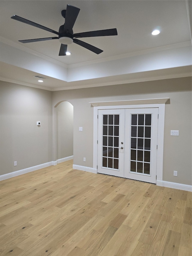 unfurnished room with ceiling fan, french doors, crown molding, and light hardwood / wood-style floors