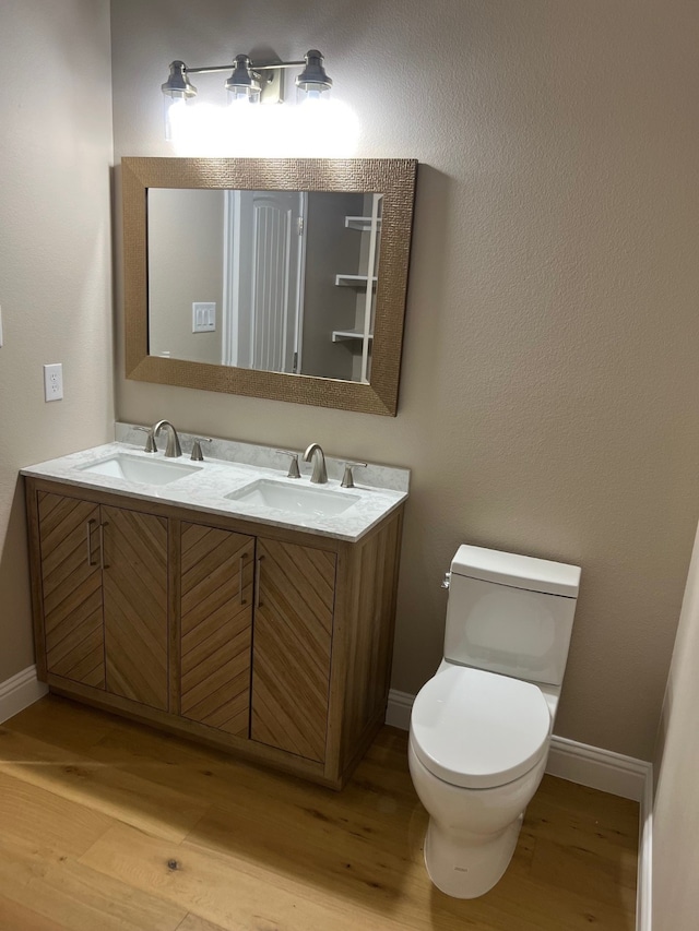 bathroom featuring vanity, hardwood / wood-style floors, and toilet