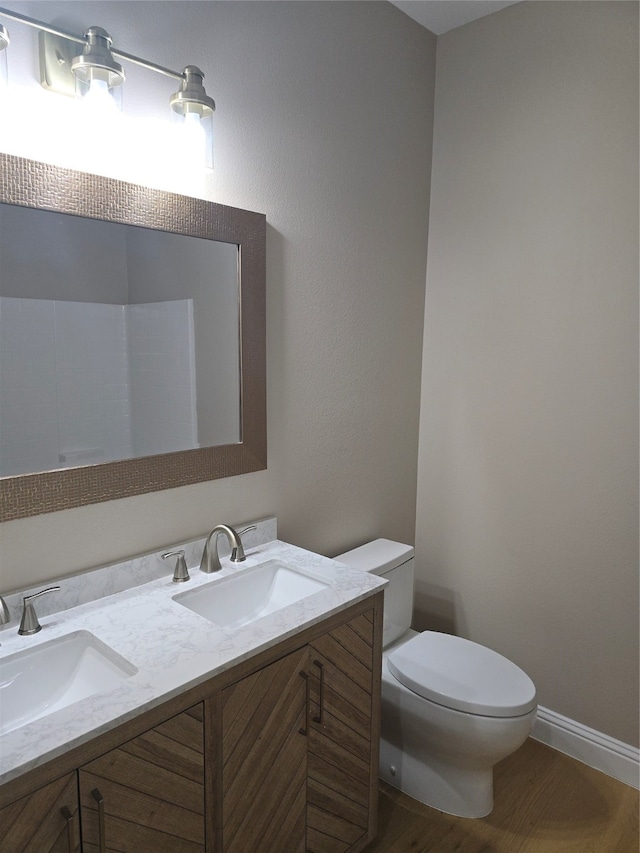 bathroom featuring hardwood / wood-style floors, vanity, and toilet