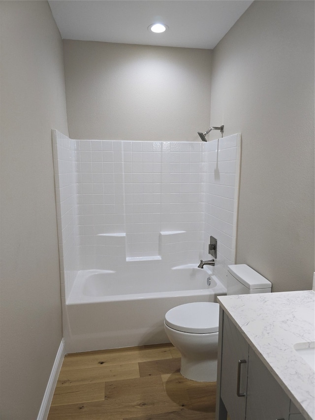 full bathroom with shower / tub combination, vanity, toilet, and hardwood / wood-style flooring