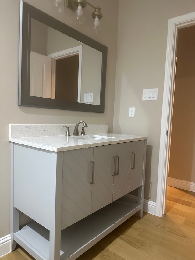 bathroom with hardwood / wood-style flooring and vanity