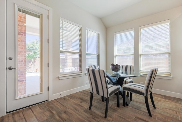 dining room with hardwood / wood-style flooring and lofted ceiling