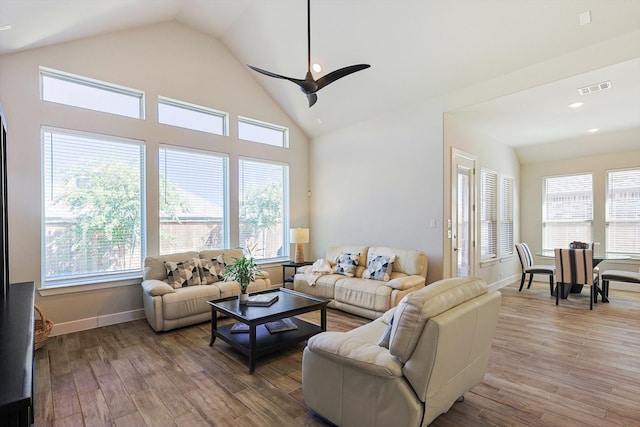 living room with hardwood / wood-style flooring, a wealth of natural light, and ceiling fan