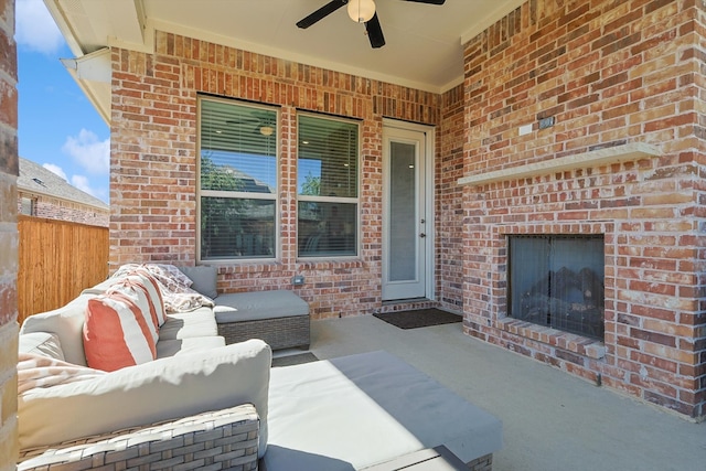 view of patio / terrace featuring an outdoor living space with a fireplace and ceiling fan