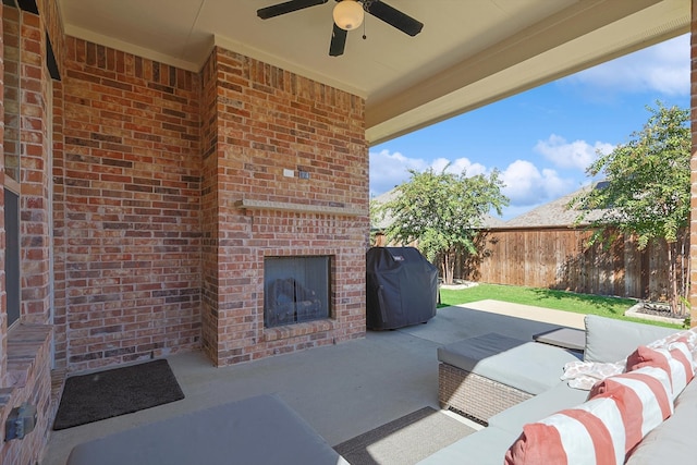 view of patio / terrace with an outdoor living space with a fireplace, ceiling fan, and grilling area