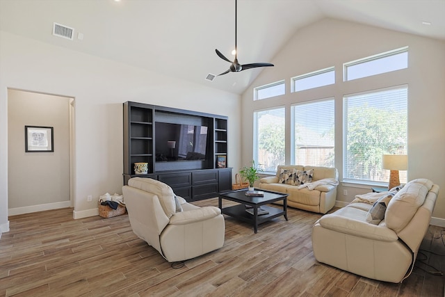 living room featuring a wealth of natural light, ceiling fan, and light hardwood / wood-style floors