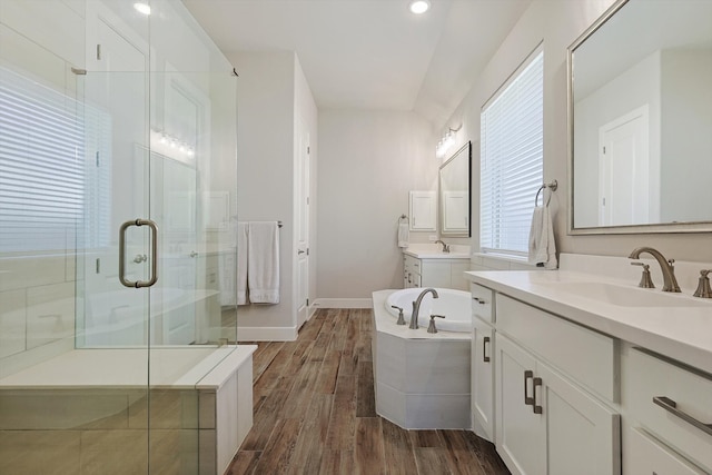 bathroom featuring hardwood / wood-style floors, vanity, and walk in shower