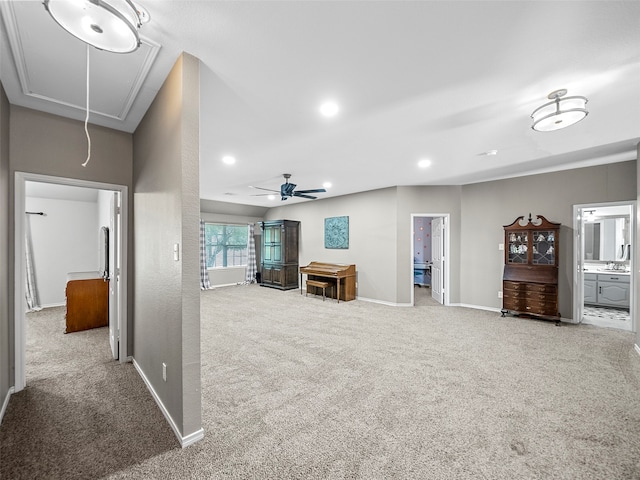 unfurnished living room with light carpet and ceiling fan