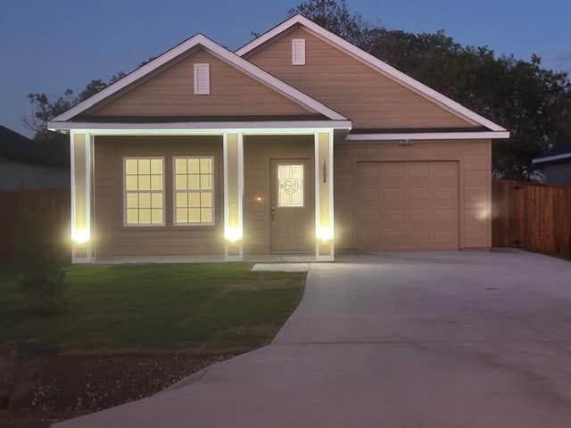 view of front of home featuring a front yard and a garage