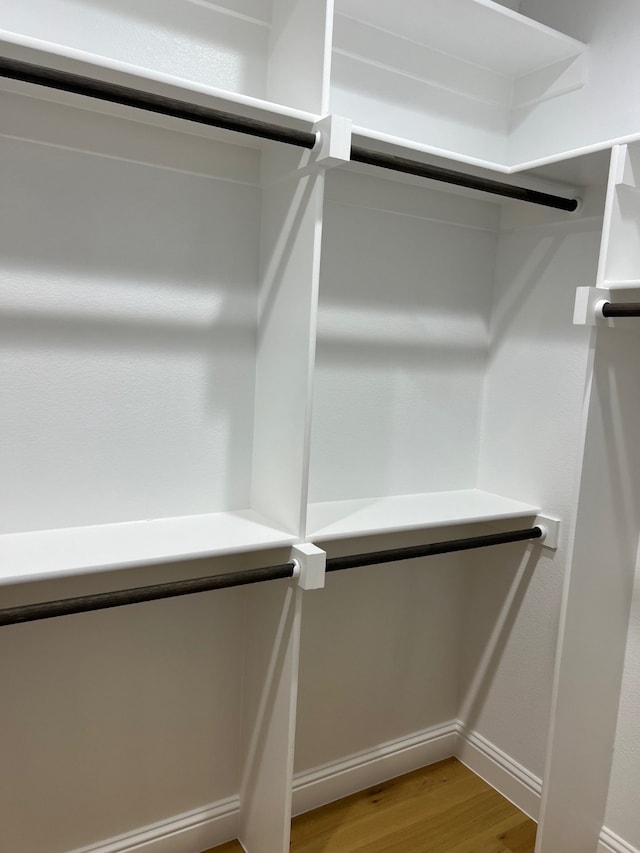 walk in closet featuring light hardwood / wood-style flooring