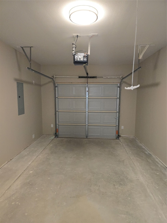 garage with a garage door opener and electric panel