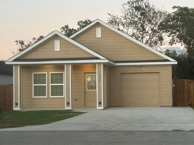 1008 S Preston St, Ennis, TX 75119 - view of front facade featuring concrete driveway and a garage
