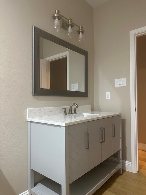 bathroom with vanity and hardwood / wood-style flooring