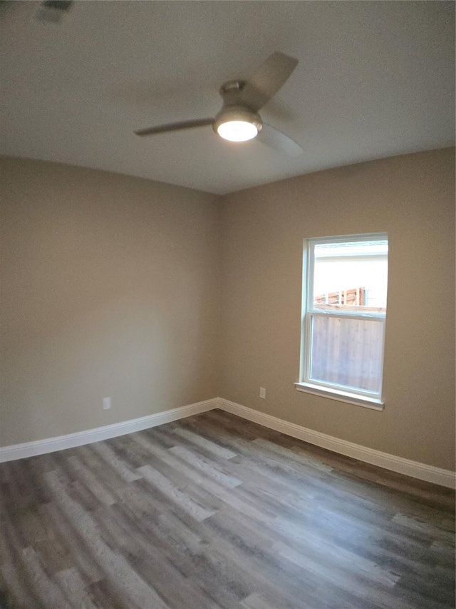 1010 S Preston St, Ennis, TX 75119 - spare room with ceiling fan, dark wood-style flooring, and baseboards