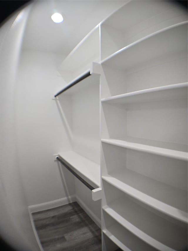 1010 S Preston St, Ennis, TX 75119 - spacious closet with dark wood-style flooring