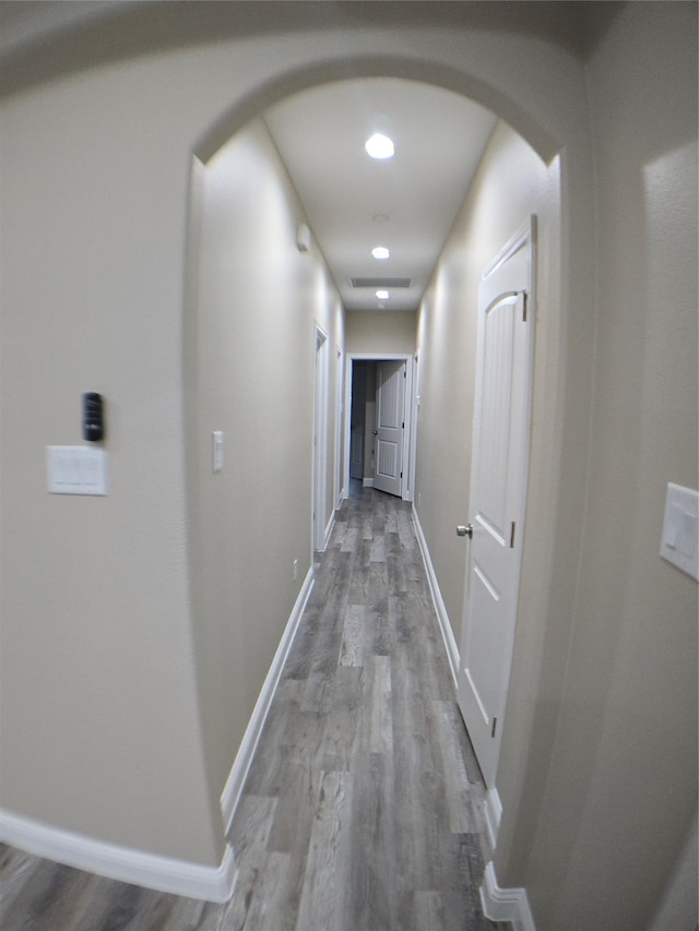 corridor with hardwood / wood-style floors