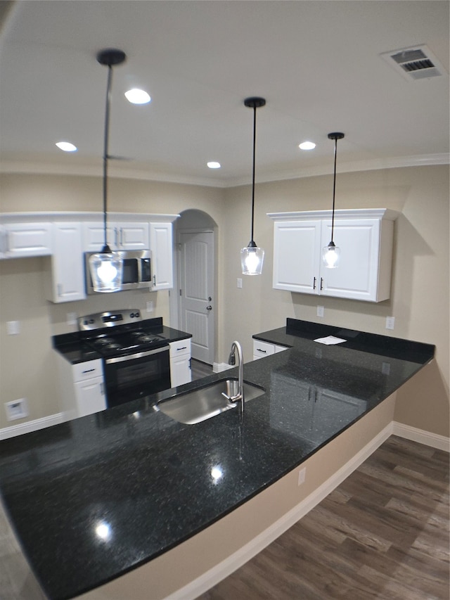 kitchen featuring white cabinetry, dark wood-type flooring, pendant lighting, stainless steel appliances, and sink