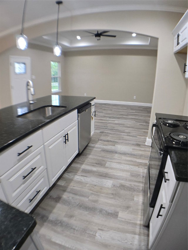 kitchen featuring sink, light hardwood / wood-style flooring, white cabinetry, and stainless steel dishwasher