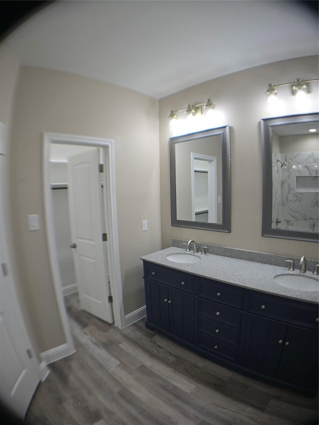 1010 S Preston St, Ennis, TX 75119 - bathroom with double vanity and wood finished floors