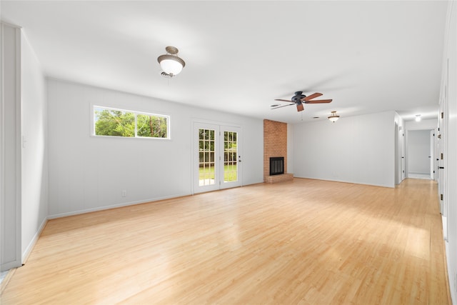 unfurnished living room featuring ceiling fan, a fireplace, and light hardwood / wood-style floors