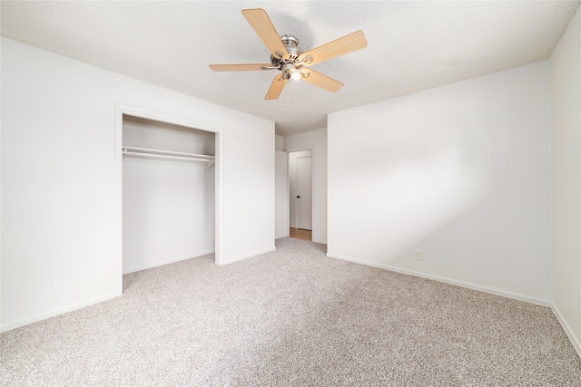 unfurnished bedroom with ceiling fan, a closet, and carpet