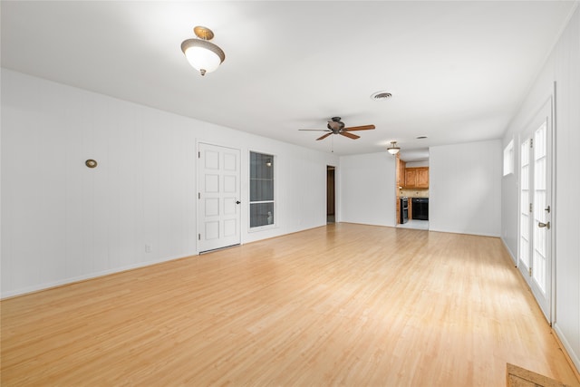 unfurnished living room featuring ceiling fan and light wood-type flooring