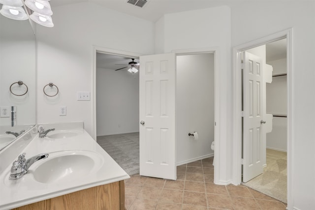 bathroom featuring tile patterned floors, ceiling fan, vanity, and toilet