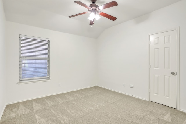 carpeted empty room with ceiling fan and lofted ceiling