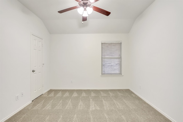 unfurnished room with vaulted ceiling, ceiling fan, and light colored carpet