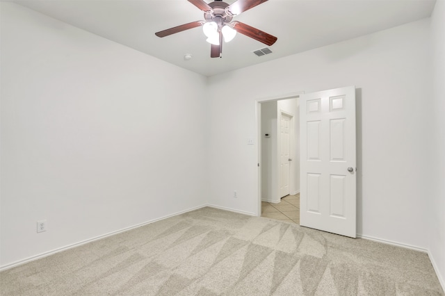 carpeted spare room featuring ceiling fan