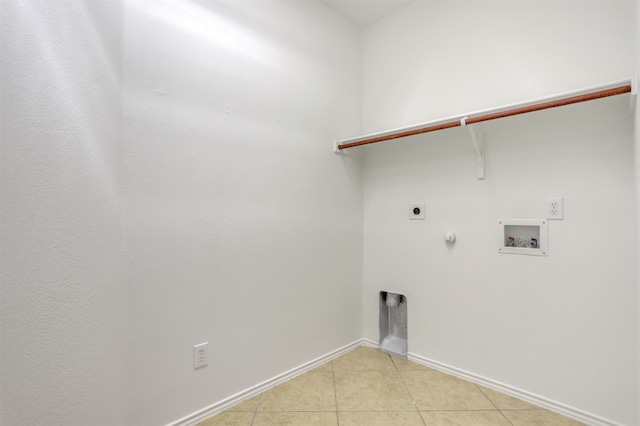 washroom with washer hookup, gas dryer hookup, light tile patterned floors, and hookup for an electric dryer