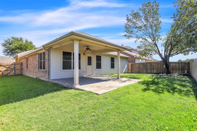 rear view of house with ceiling fan, a lawn, and a patio area