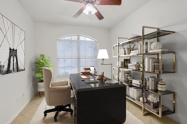 home office with a ceiling fan, baseboards, and tile patterned floors