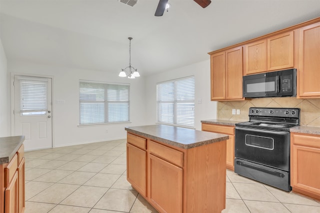 kitchen featuring black appliances, ceiling fan with notable chandelier, a center island, and plenty of natural light