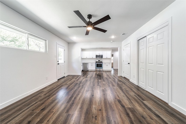 1504 Nichols St, Ennis, TX 75119 - unfurnished living room with ceiling fan and dark wood-style floors
