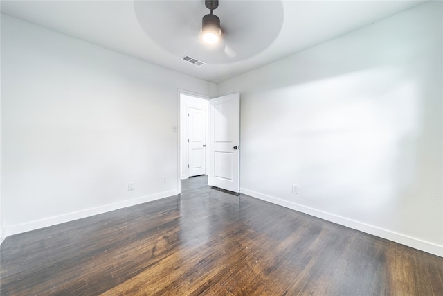 spare room with ceiling fan and dark hardwood / wood-style floors